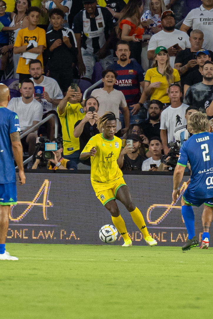 Andone Law-sponsored player in branded yellow kit at an Orlando match.
